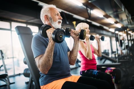 Man and woman lifting weights