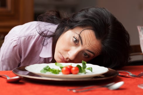 Tired woman with head on table